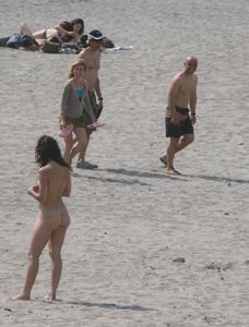 Topless girl goes full-nudist at textile beach  Almeria (Spain)-z6w4xudlcn.jpg