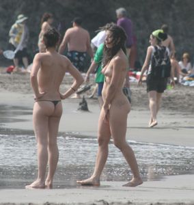Topless girl goes full-nudist at textile beach  Almeria (Spain)-r6w4xu2dmg.jpg