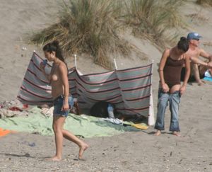 Topless girl goes full-nudist at textile beach  Almeria (Spain)-06w4xuuz06.jpg